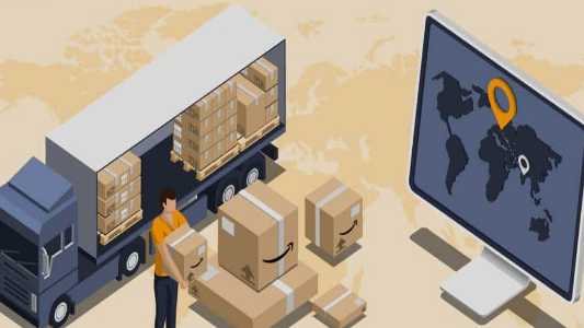 A freight worker checks the goods on a computer next to a truck.